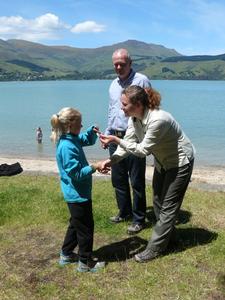 Emmy-Lou Abbott receives her badge from DOC Communications and Engagement Advisor Sarah Mankelow and Canterbury Conservator Mike Cuddihy  
